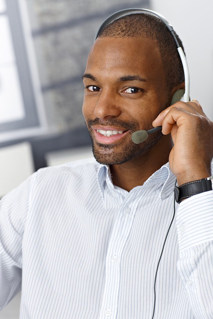 911_dispatcher_man_working male dispatcher talking assisting with his headset