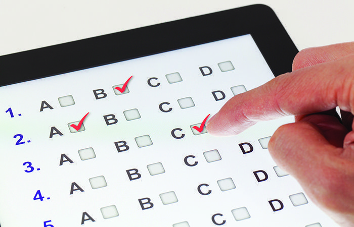 custom_entry_level_exam_io_solutions person taking a custom exam on a tablet