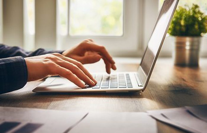 io_solutions_background man working on a laptop for io solutions background image