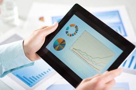 research_development_io_solutions a person looking at data on an ipad to represent research and development